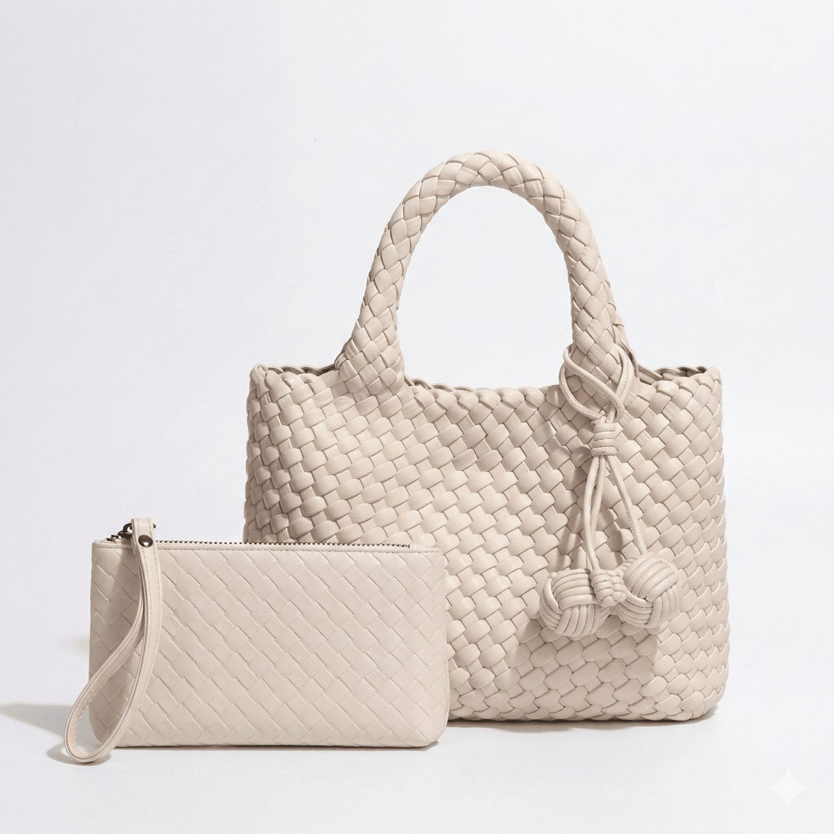 Daya Mini Woven Tote Bag in Ivory with pewter-tone hardware and decorative monkey fist knot bag charm